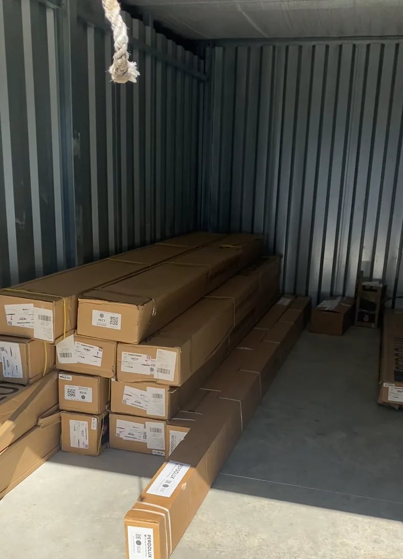 Builder's boxed materials stacked in a storage unit for a contractor